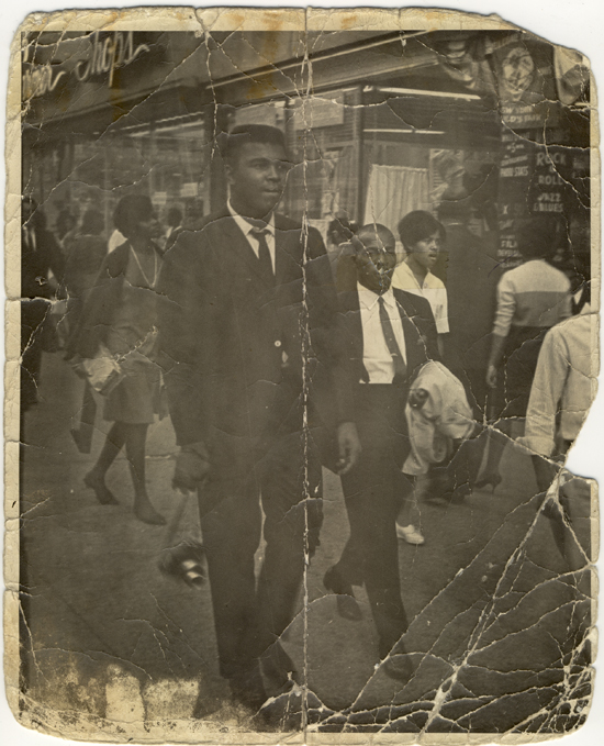 Cassius Clay on the street with his bodyguard