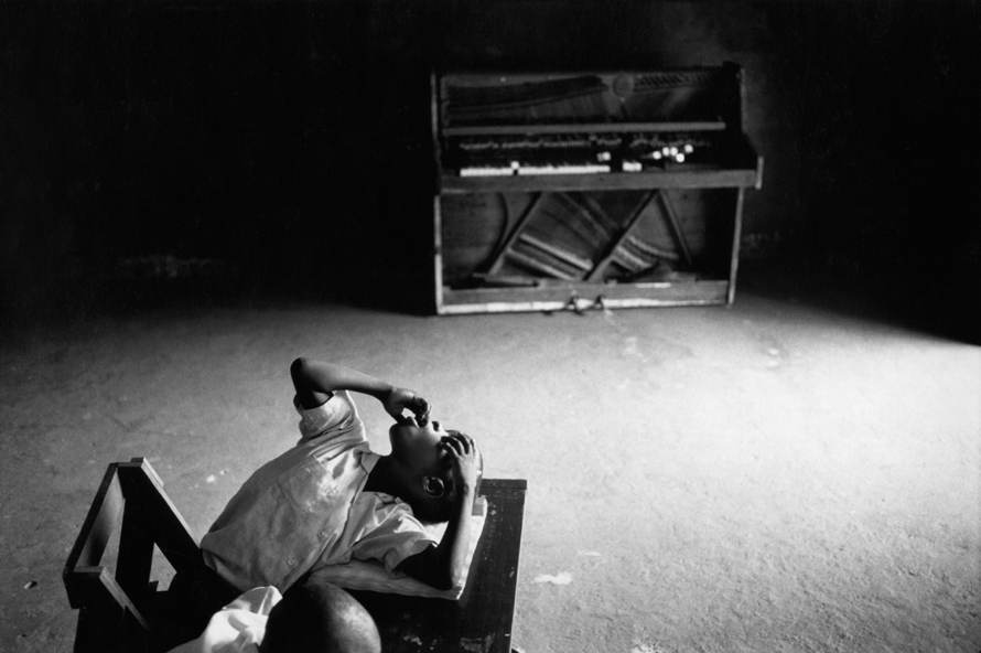 Untitled, 1999-2003 (young boy with piano), © Tim Hetherington, Courtesy Yossi Milo Gallery, New York